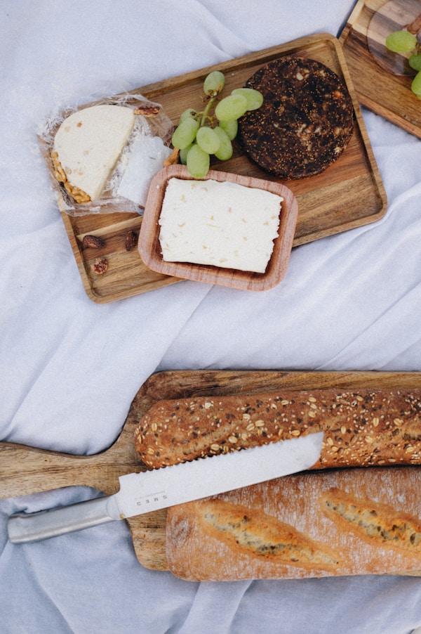 A cutting board with cheese and bread