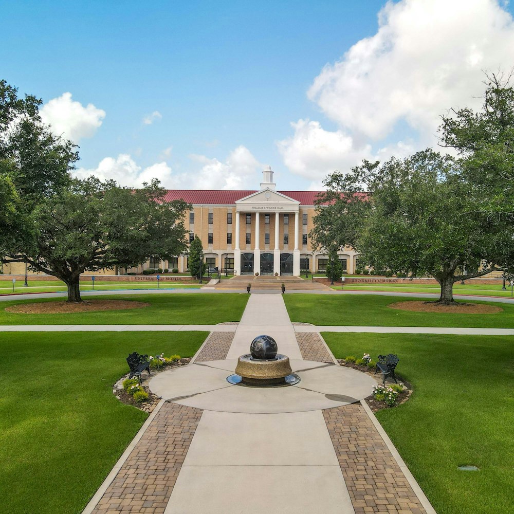 a large building with a fountain in front of it