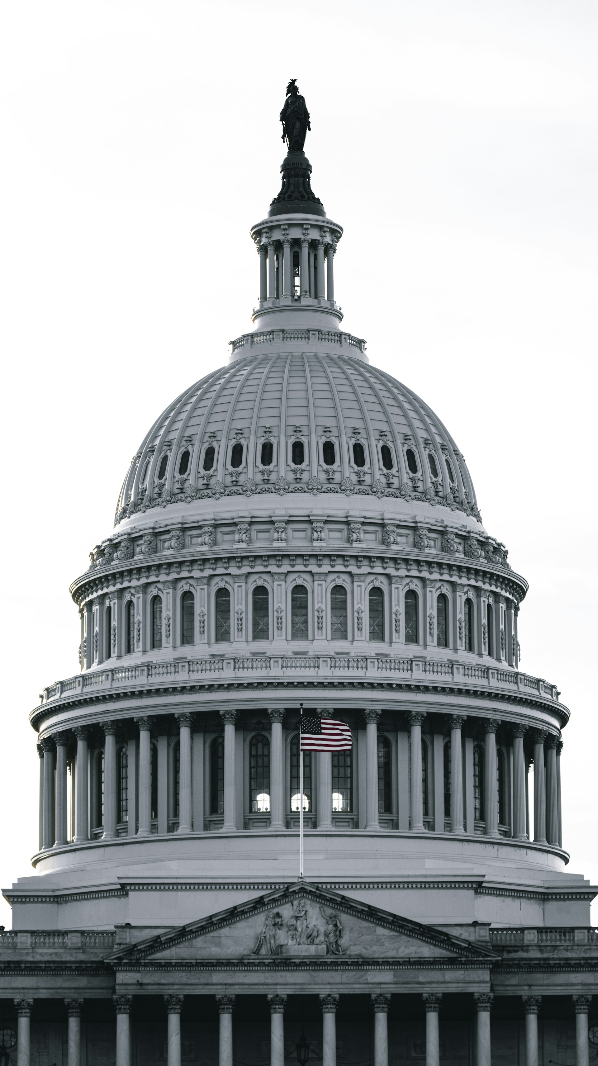 a large white building with a statue on top