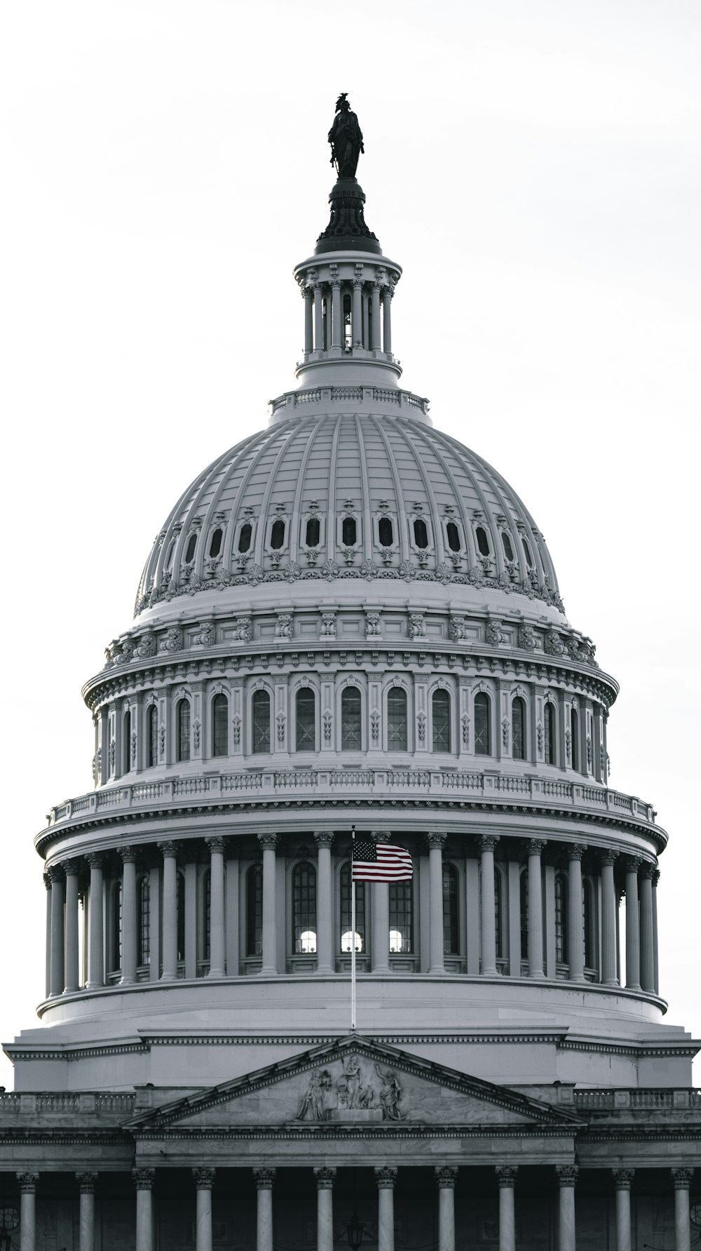 a large white building with a statue on top