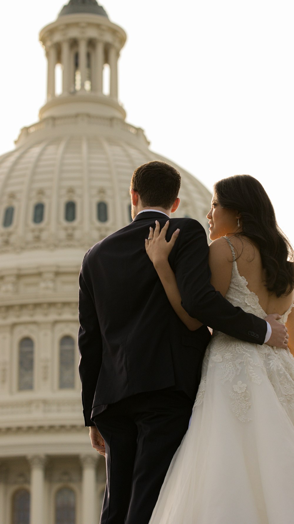 a man and woman kissing in front of a building