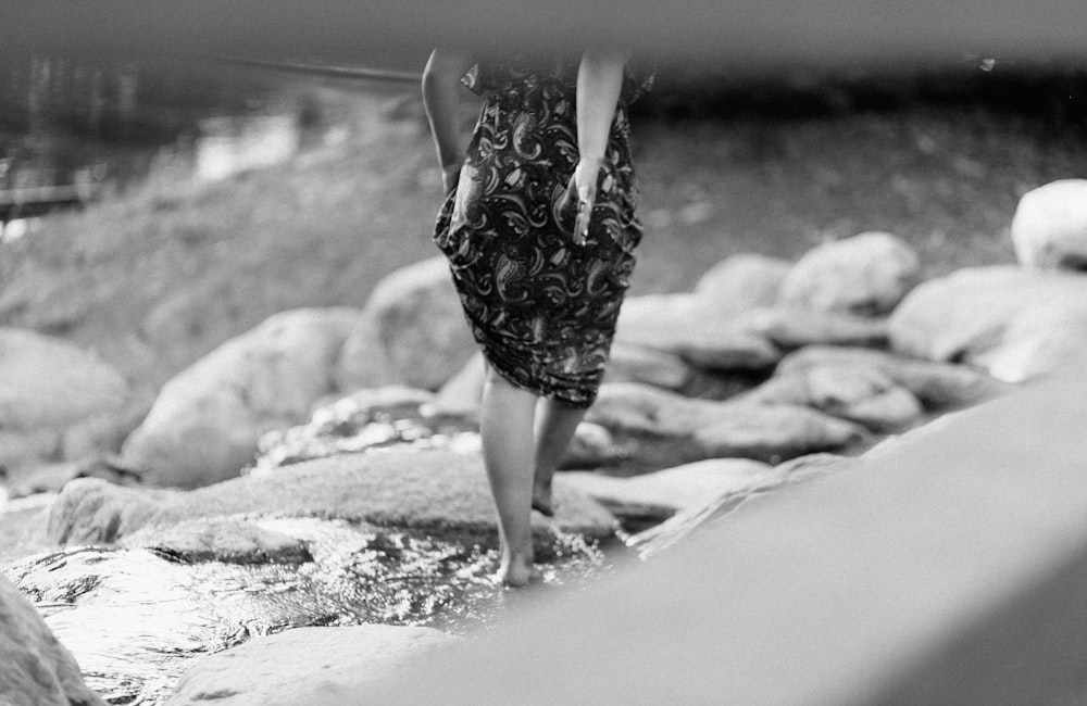 a little girl standing on rocks