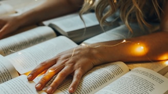 a person's hand on a book