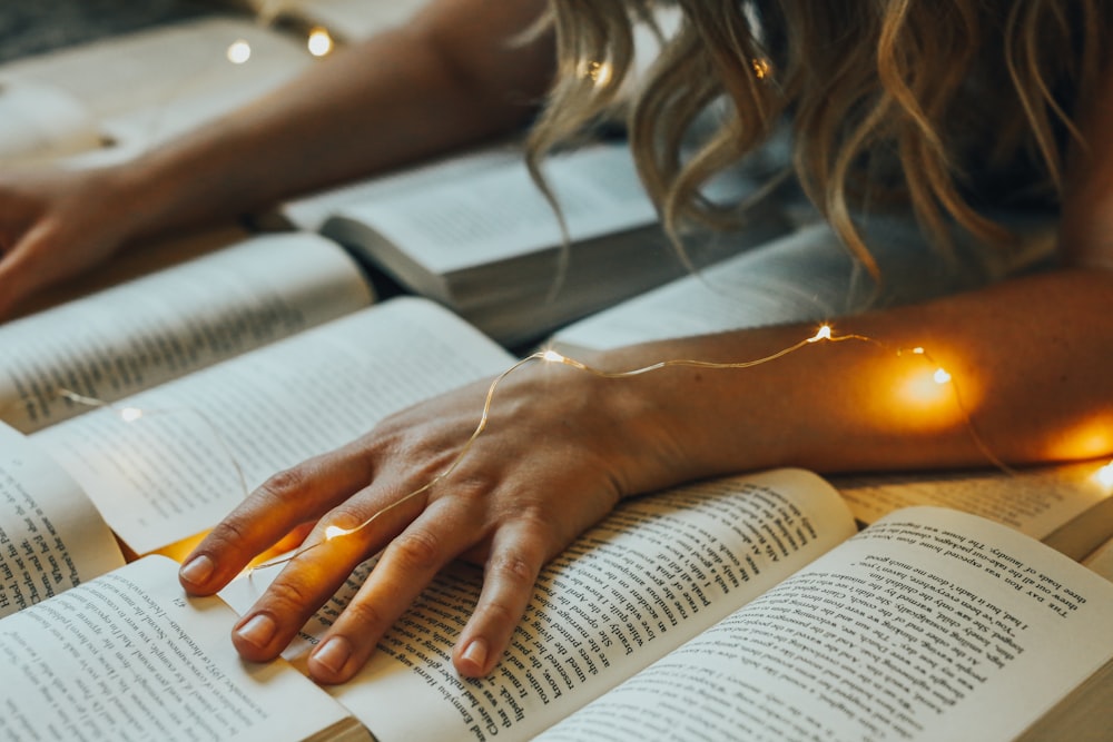 a person's hand on a book