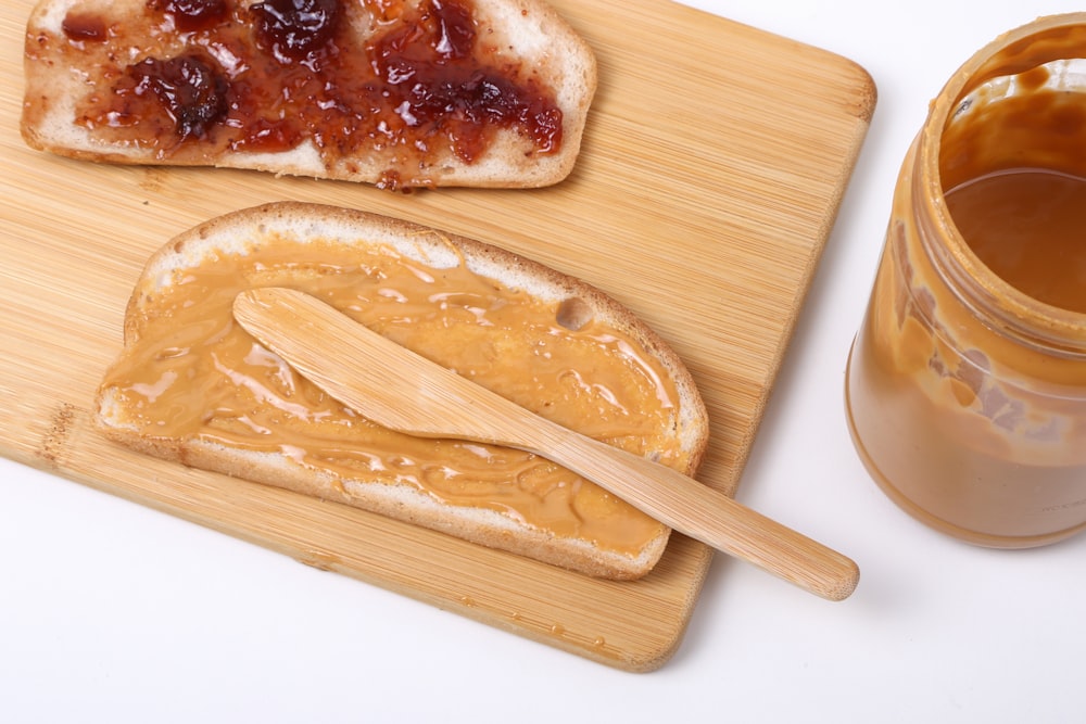 a wooden spoon next to a bowl of food