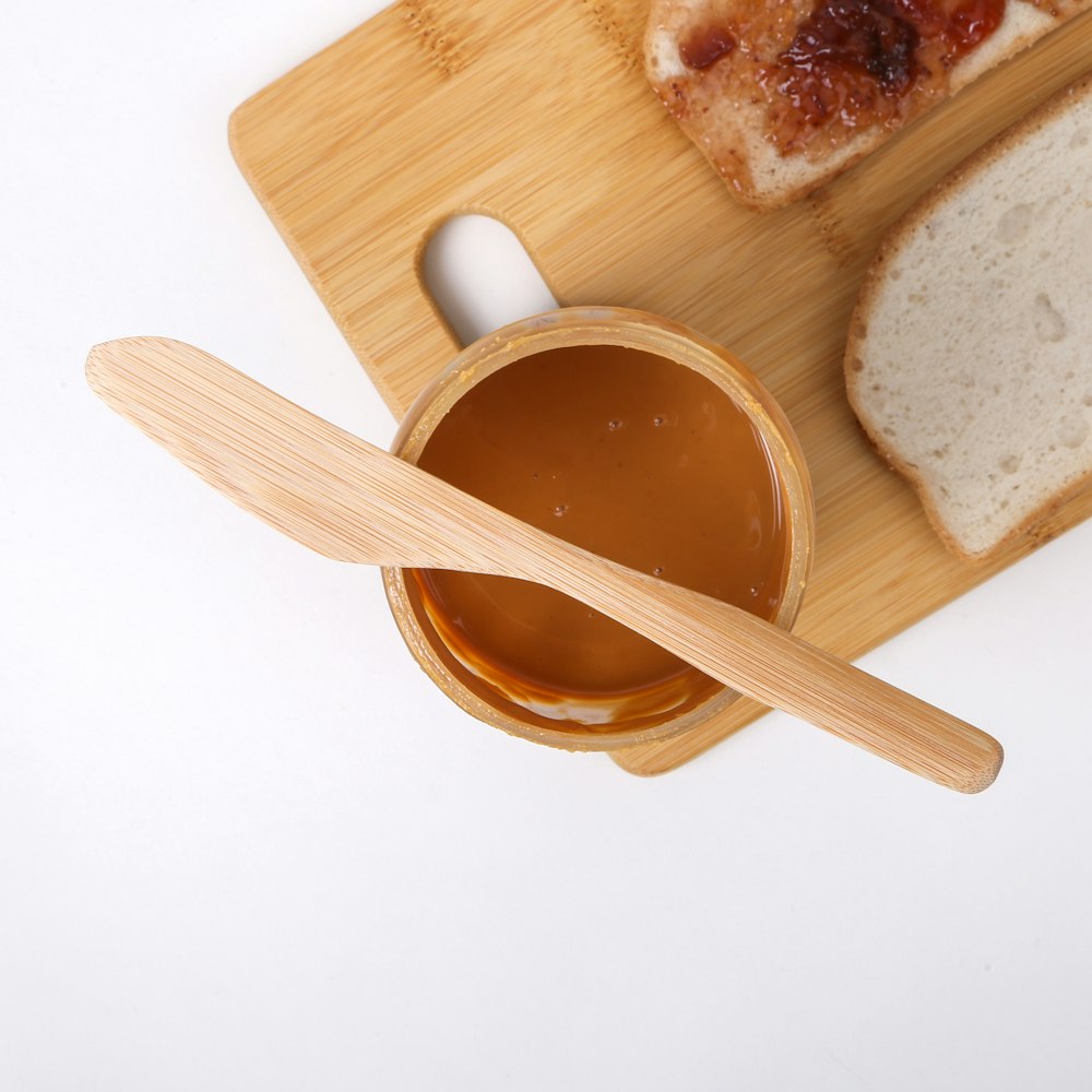 a wooden spoon in a bowl of soup