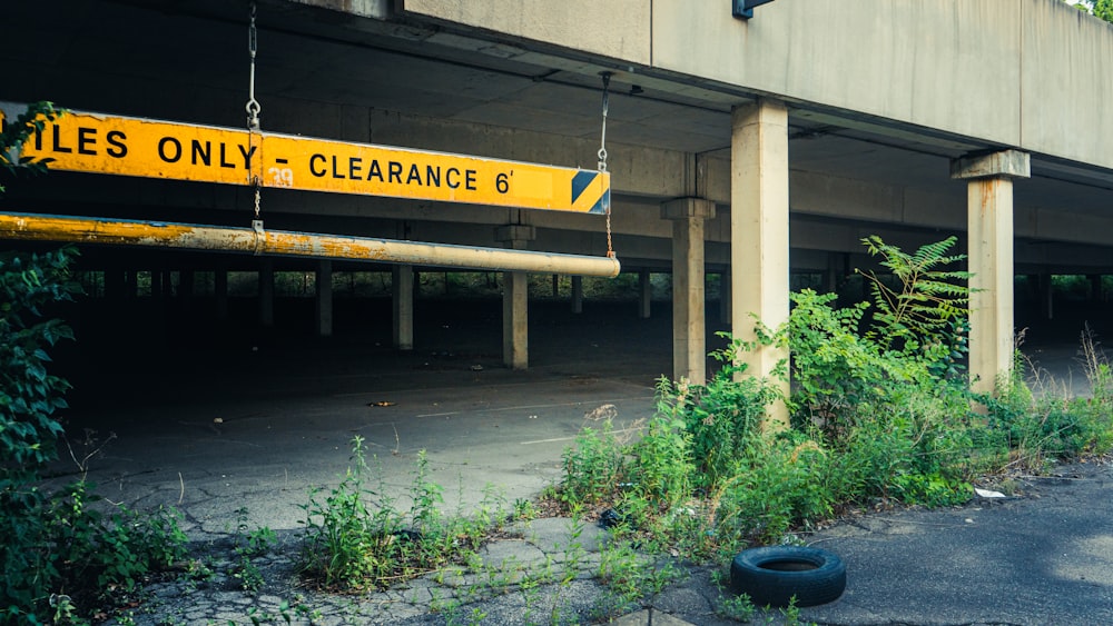 a yellow sign on a bridge