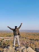 Player avatar standing victorious on a battlefield.