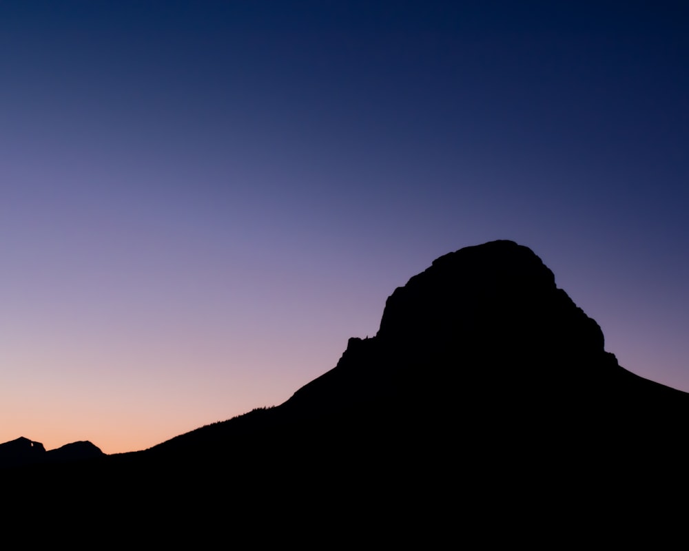 a silhouette of a mountain