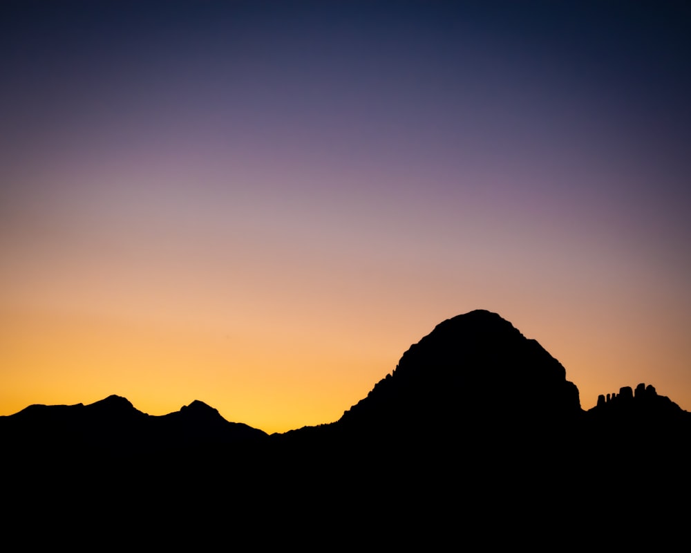 a silhouette of a mountain