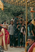 A group of women in traditional attire engaged in a community gathering.