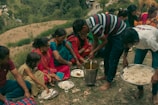 a group of people sitting around a table with food on it