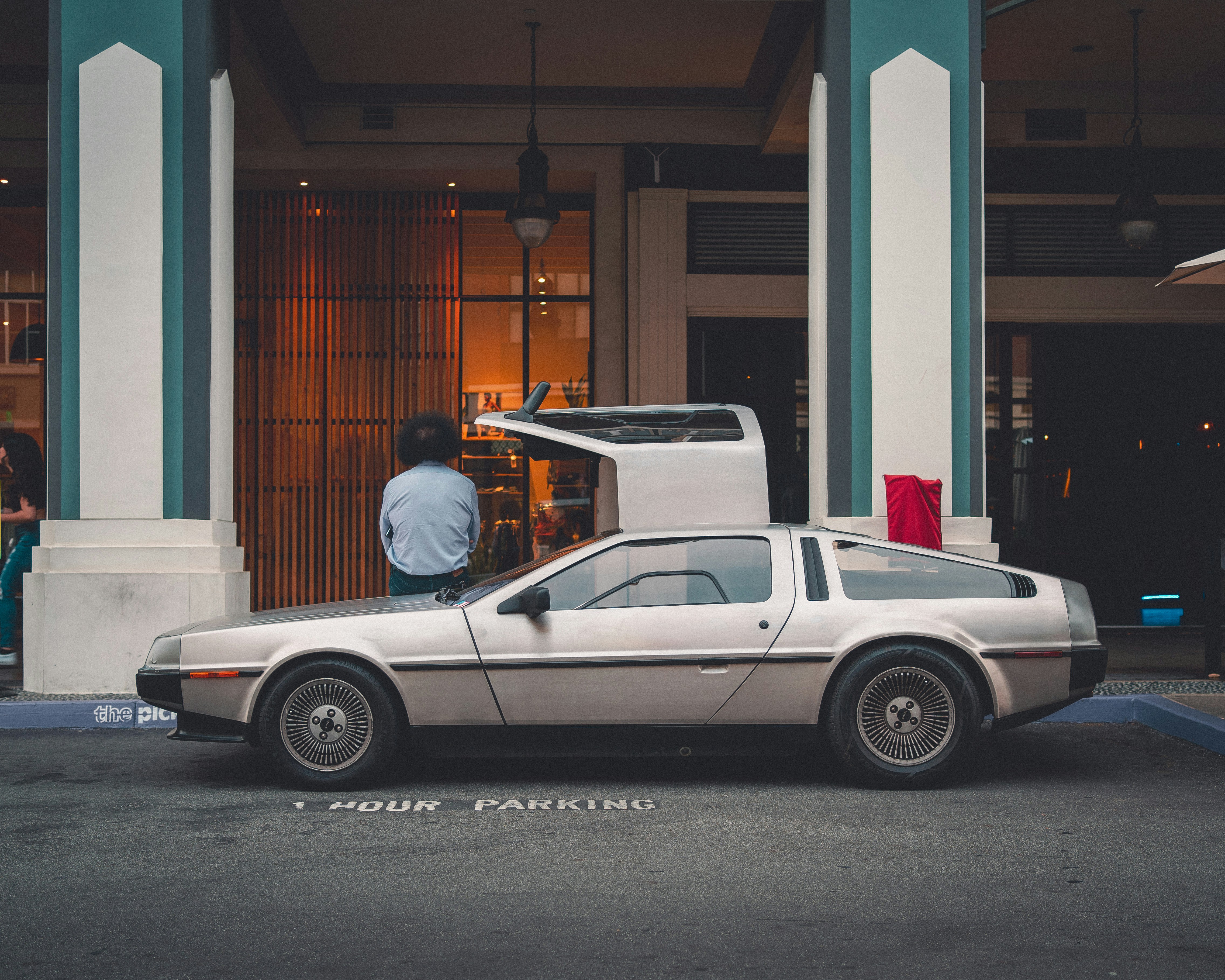 a person standing next to a car