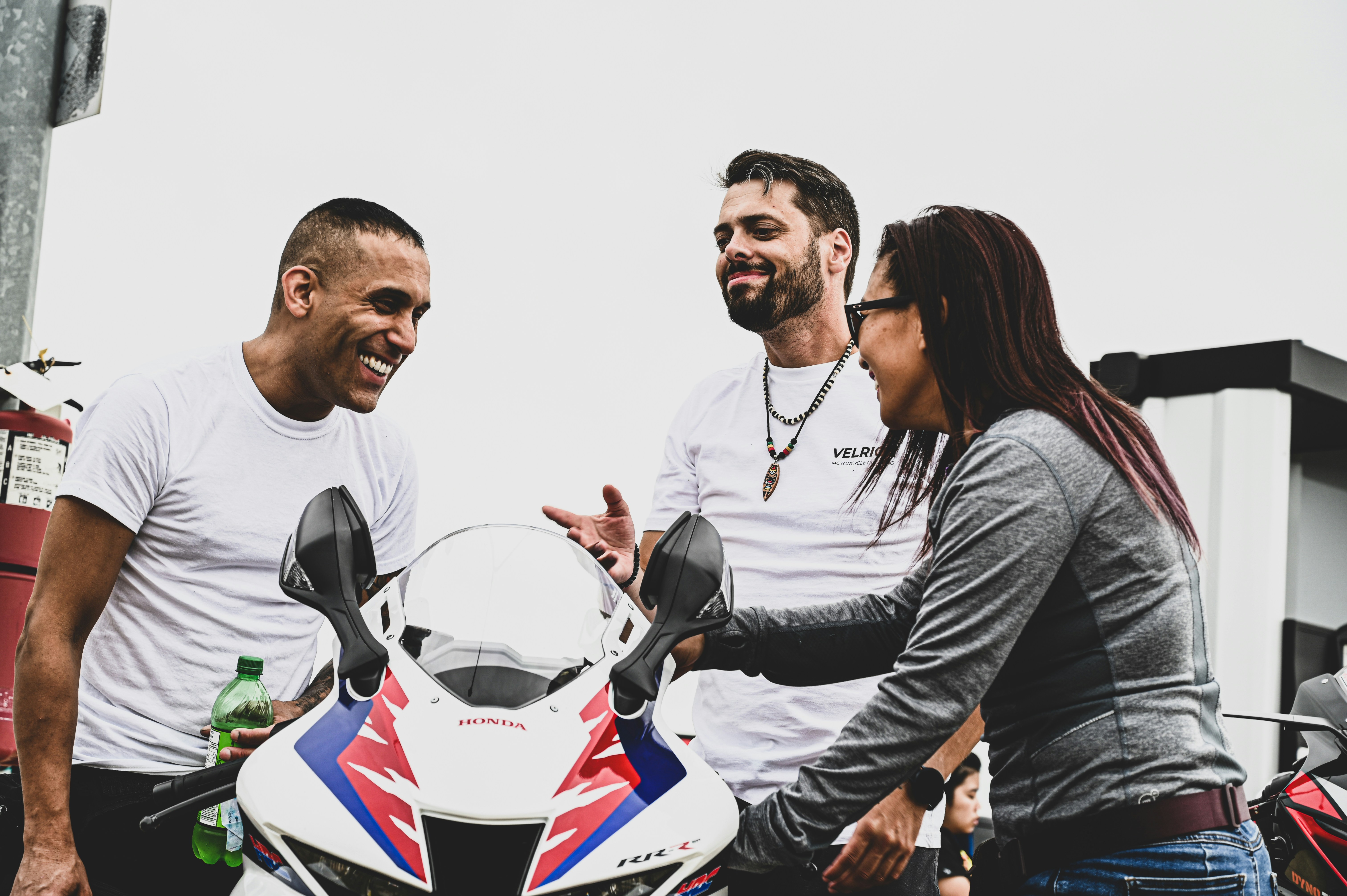 a group of people posing for a picture with a helmet