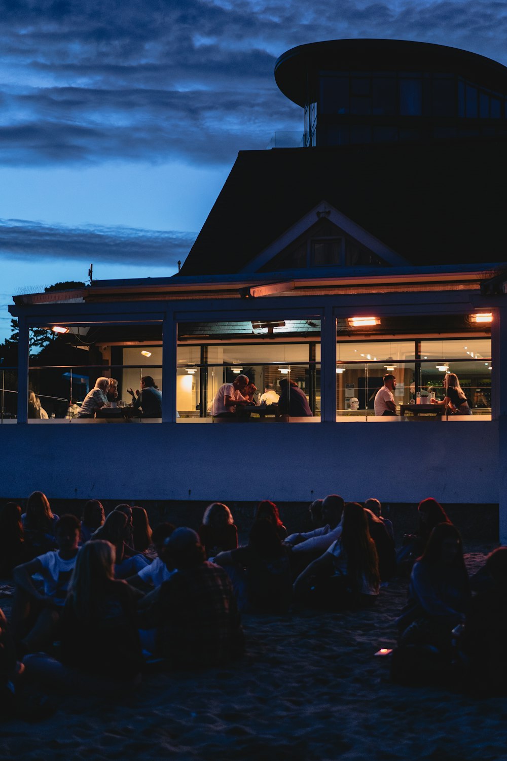 a group of people sitting outside a building