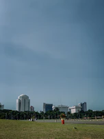 A panoramic view of Accra's skyline with waste bins neatly lined up on the sidewalks.