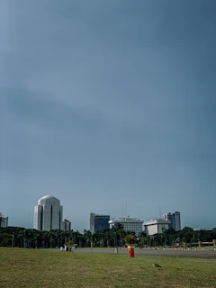 A panoramic view of Accra's skyline with waste bins neatly lined up on the sidewalks.
