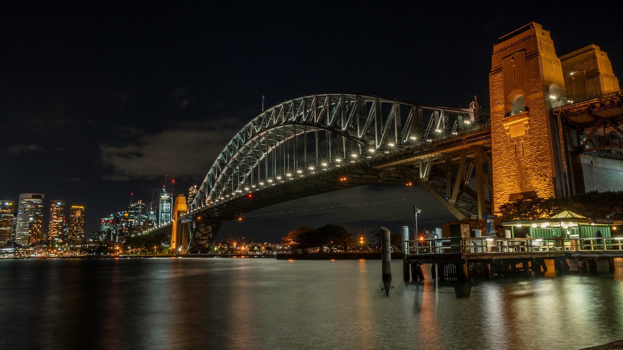 Sydney Harbour Bridge over water with a city in the background