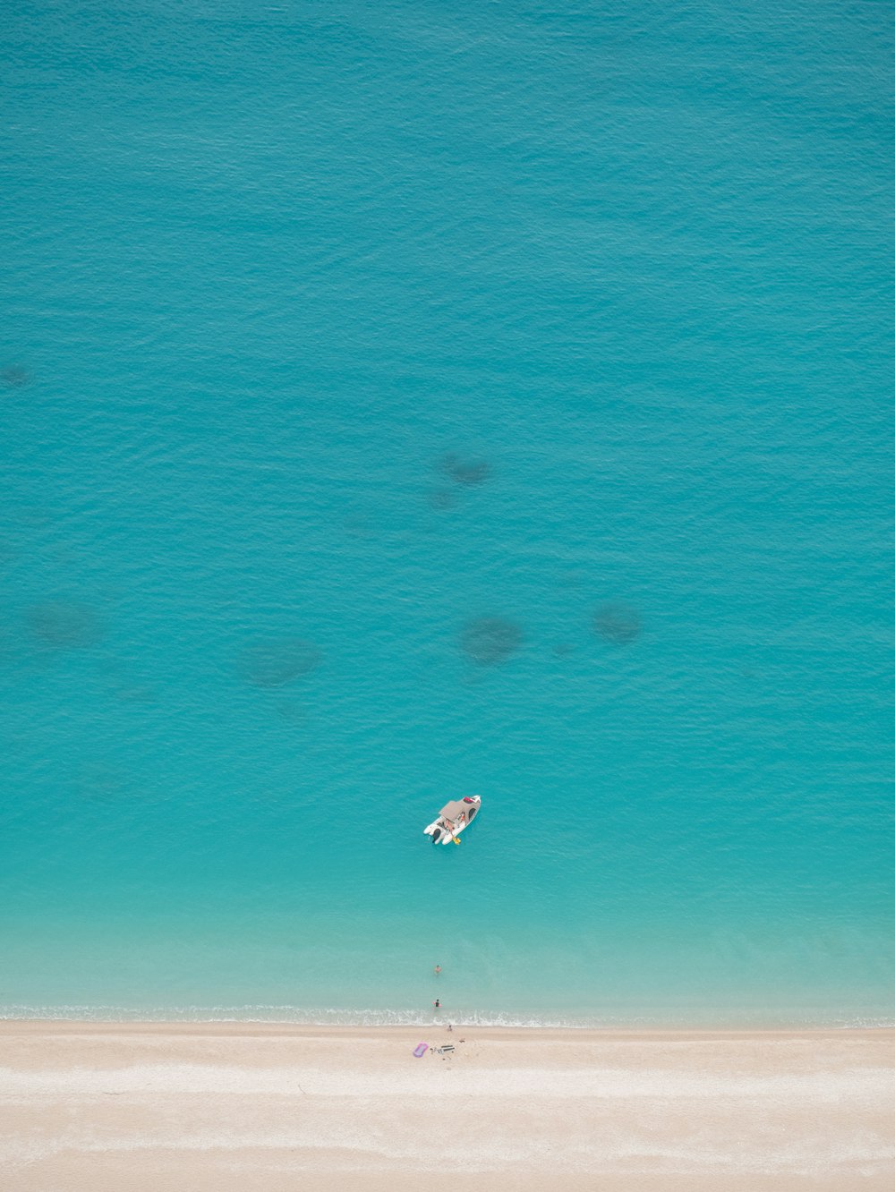 a person flying a kite on the beach