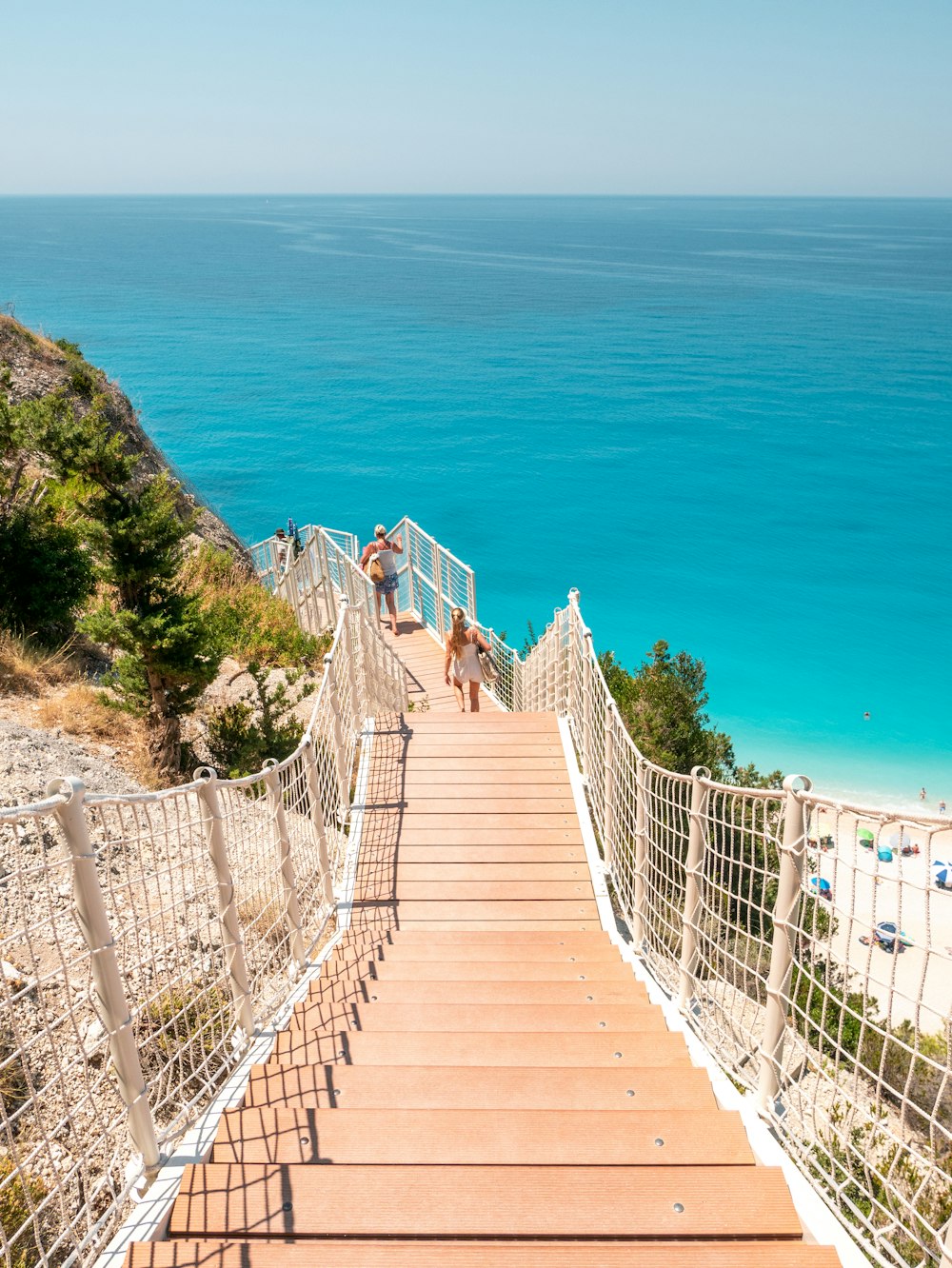 a wooden staircase leading down to a beach