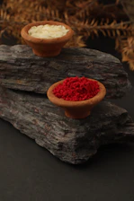 a group of small round objects with red and white powder on them