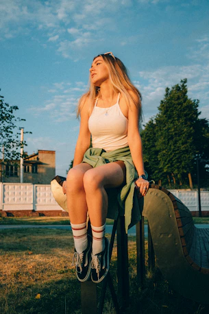 a woman sitting on a cannon
