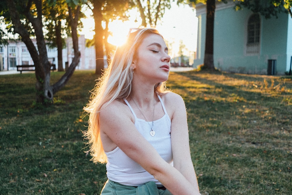 a woman standing in a grassy area