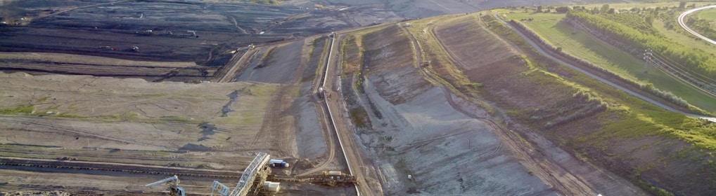 a large area with a road and fields in the background