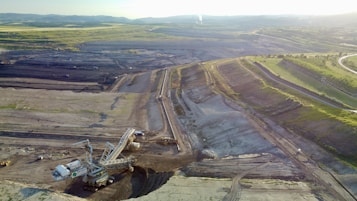 a large area with a road and fields in the background