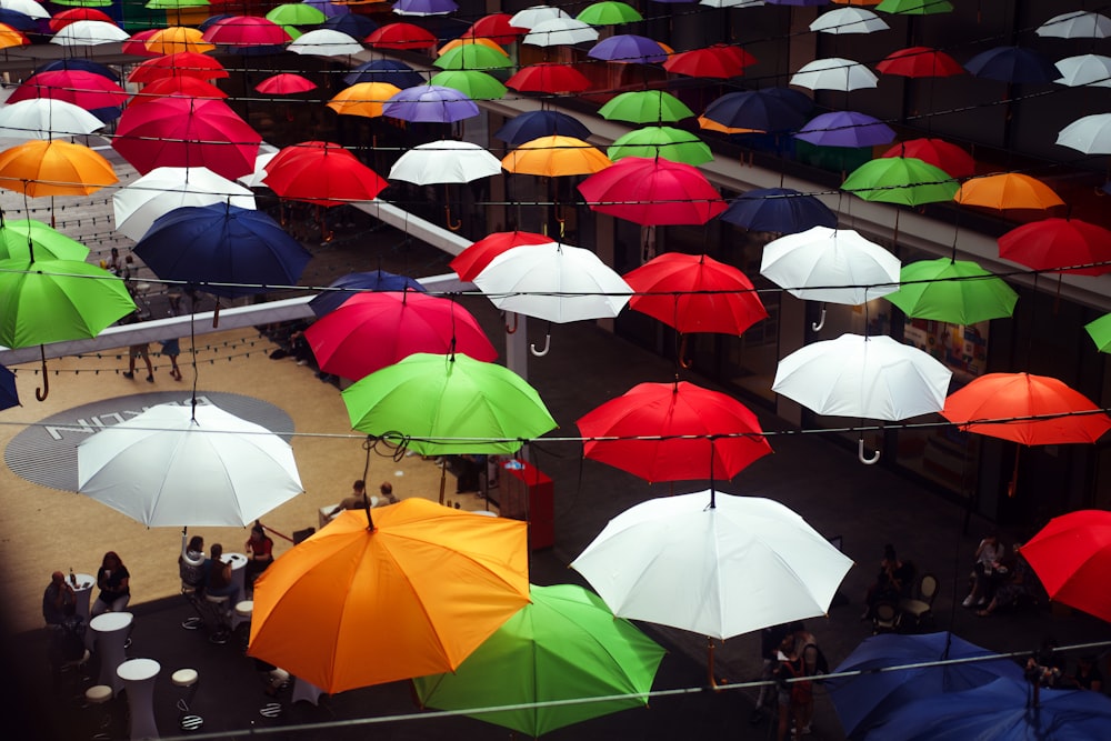 a large group of umbrellas are from the ceiling