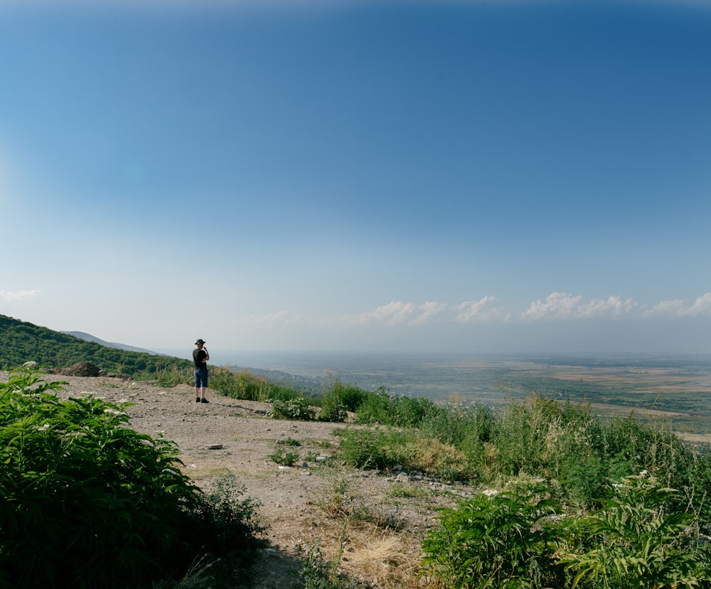 a person standing on a dirt path