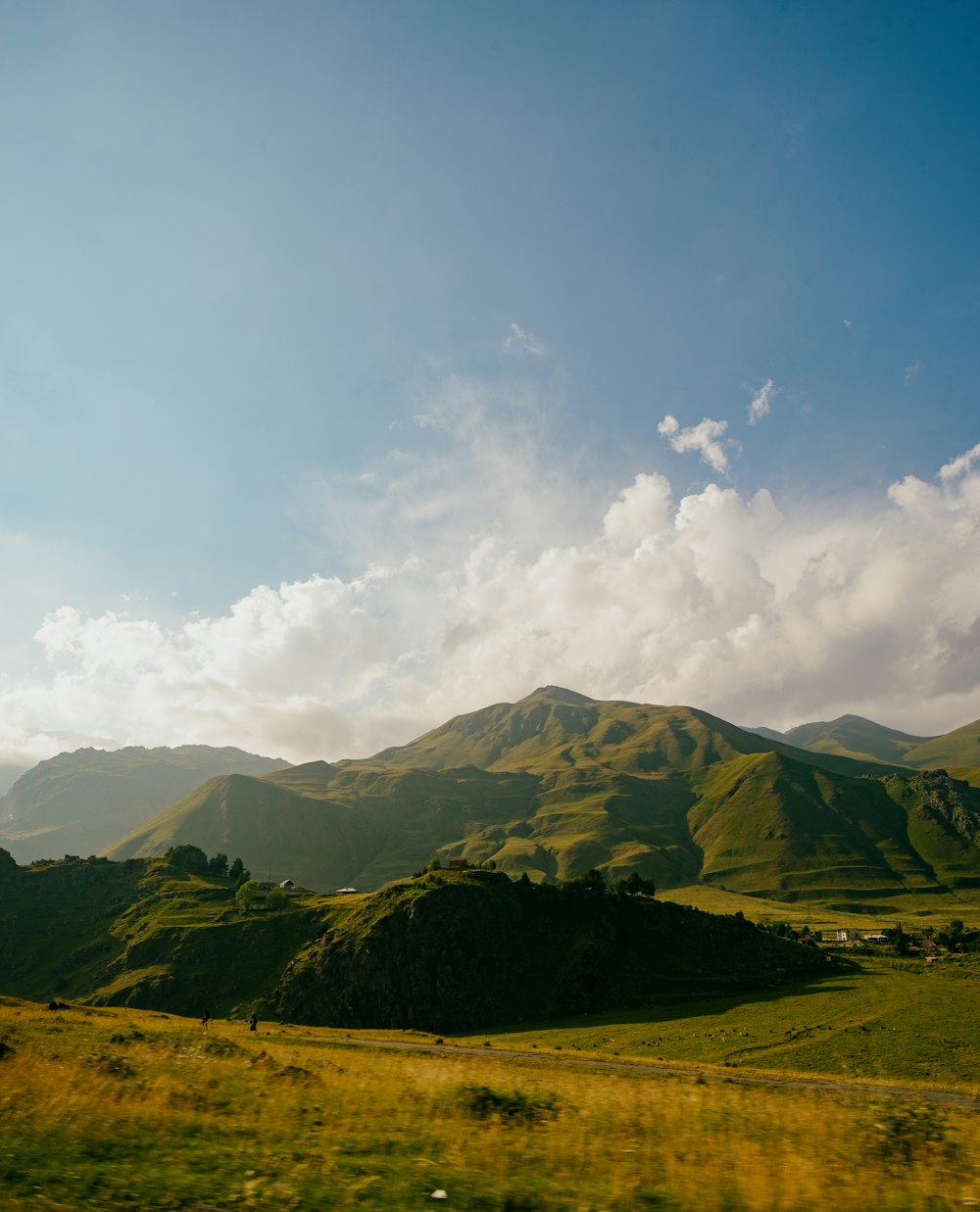 a landscape with hills and clouds