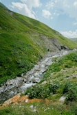 A serene mountain landscape with a winding river.