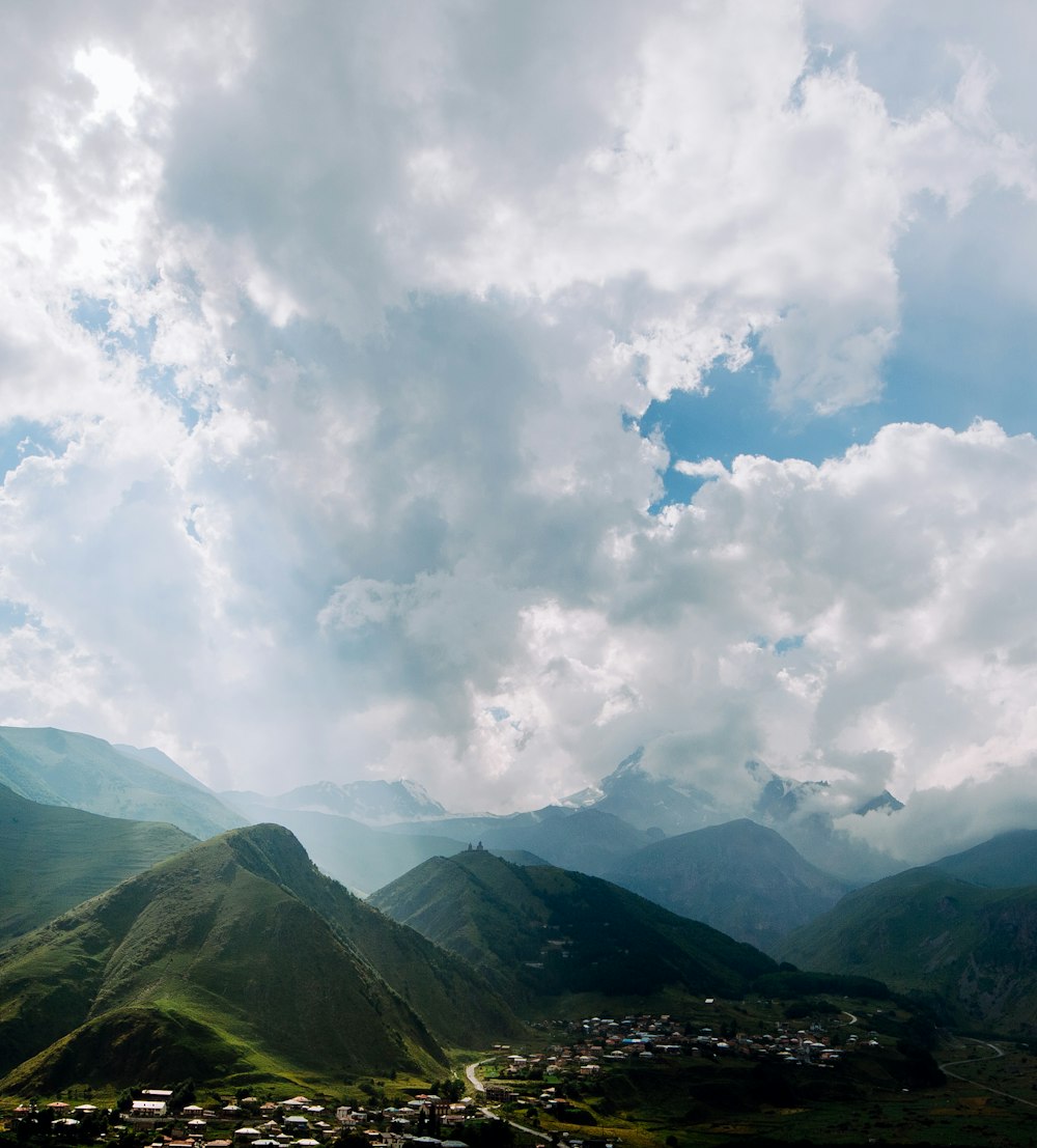 a valley with mountains in the background