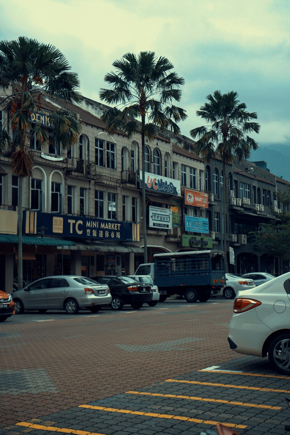 a street with cars and buildings along it