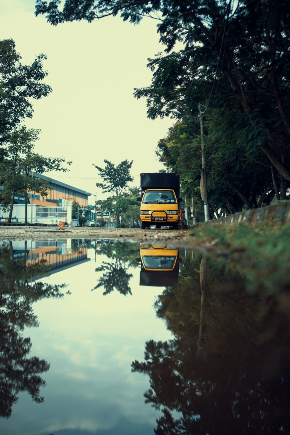 a yellow truck on a river