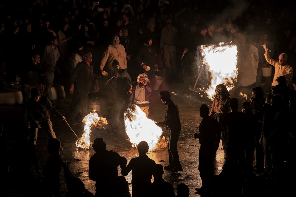 a group of people around a fire