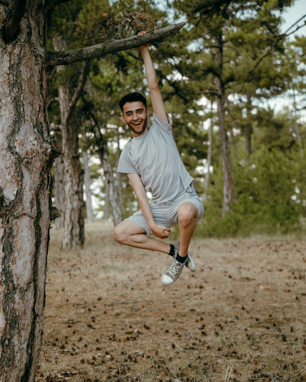 a man holding a tree branch