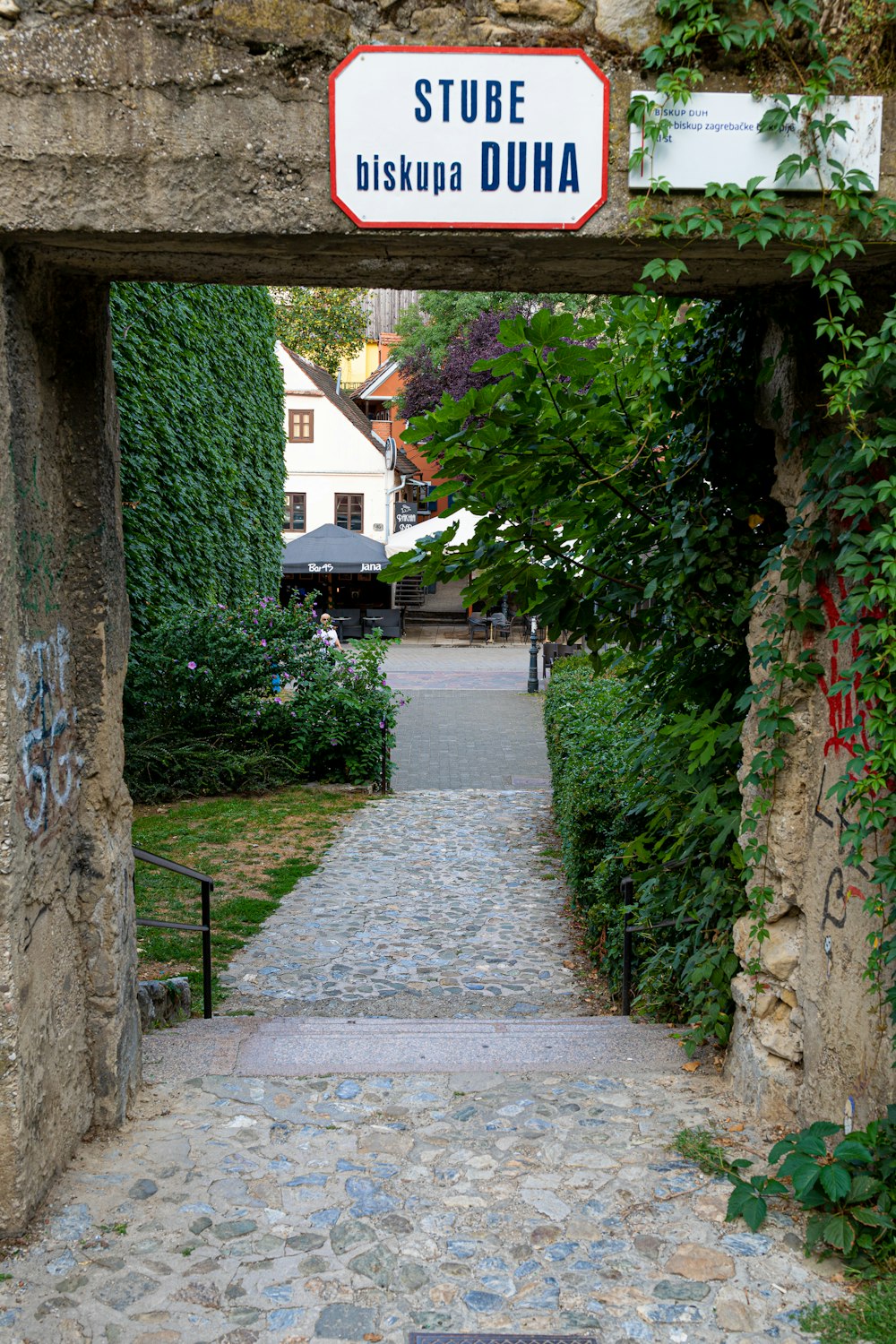 a sign on a stone wall