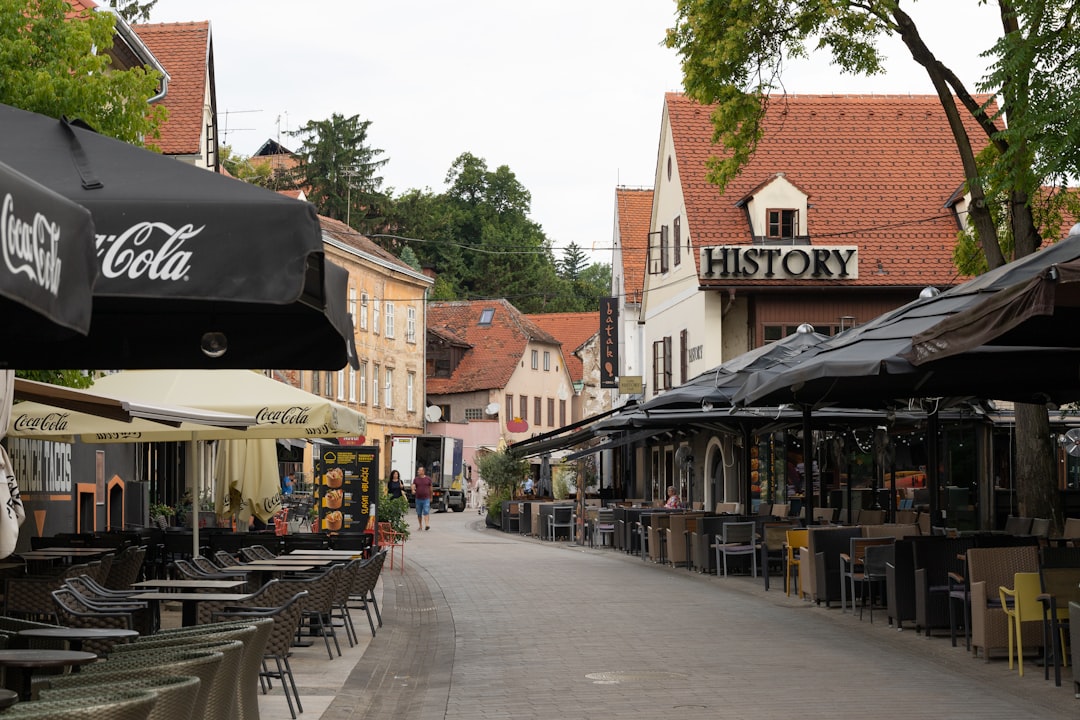 a street with tables and chairs along it,