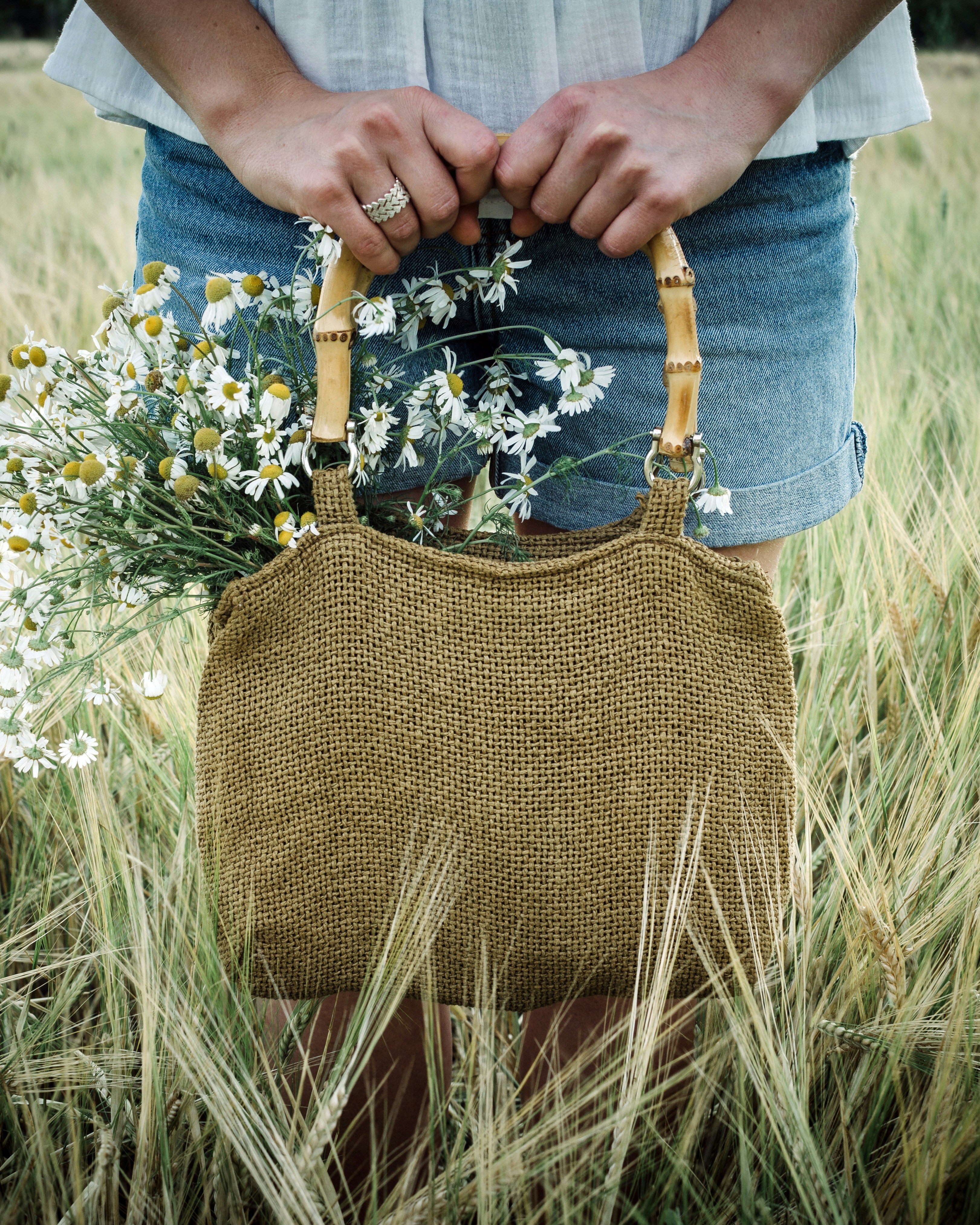 a person holding a bag of flowers