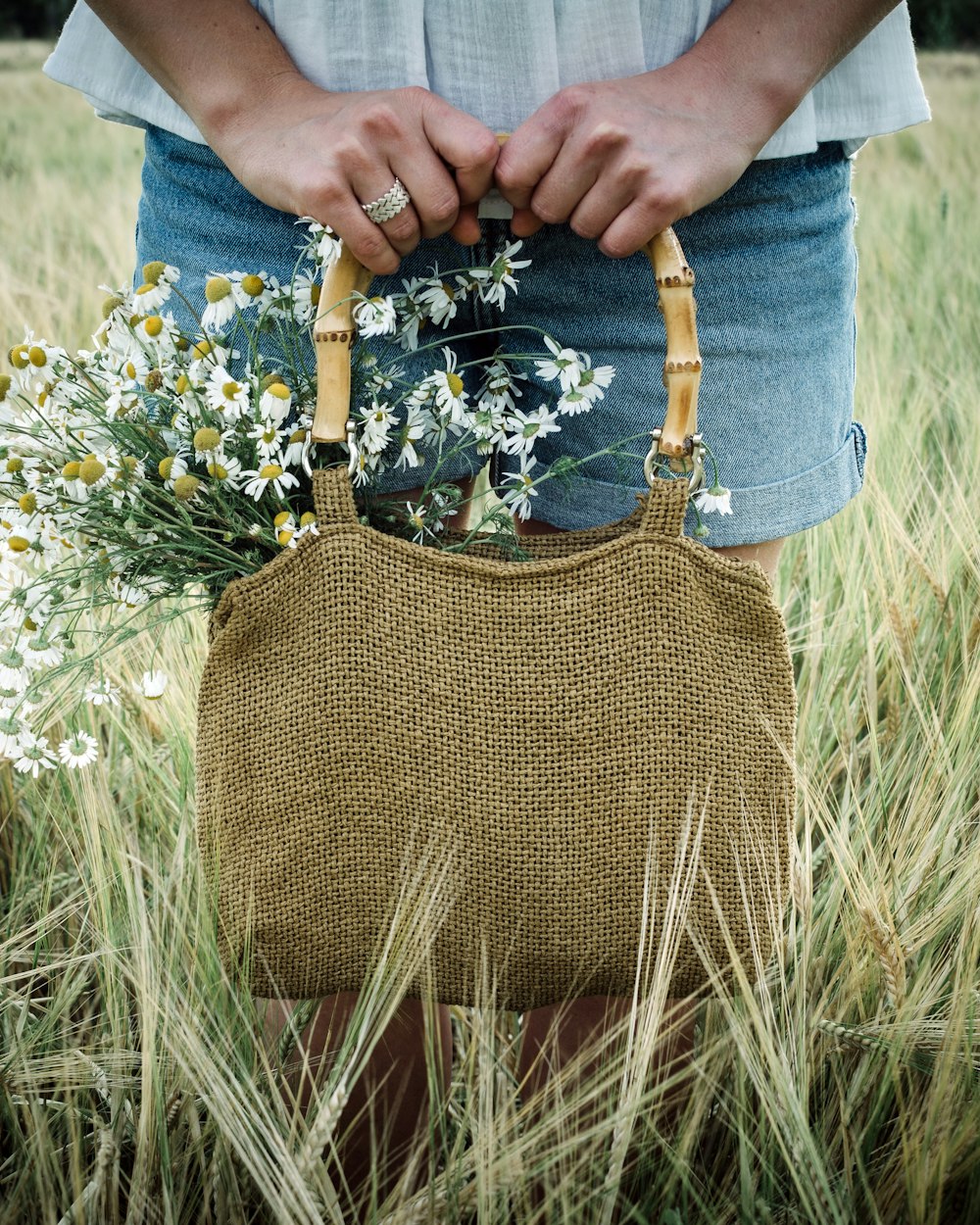 a person holding a bag of flowers