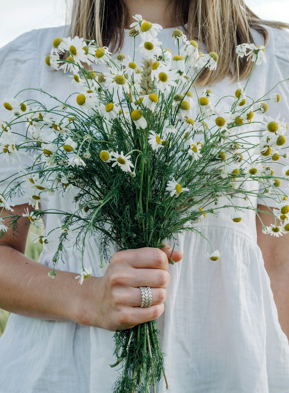 a woman holding a bouquet of flowers