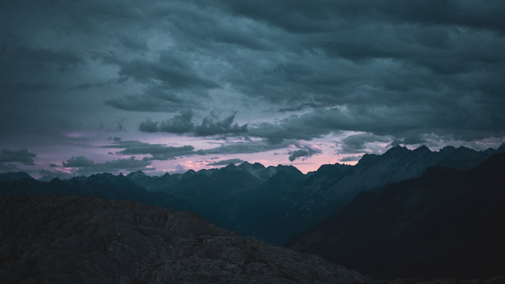 a landscape with mountains and clouds