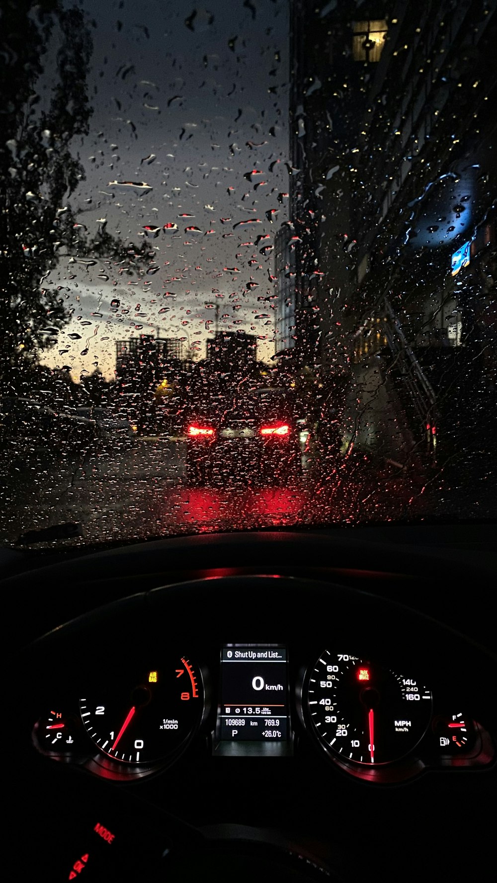 a view of a street through a windshield of a car