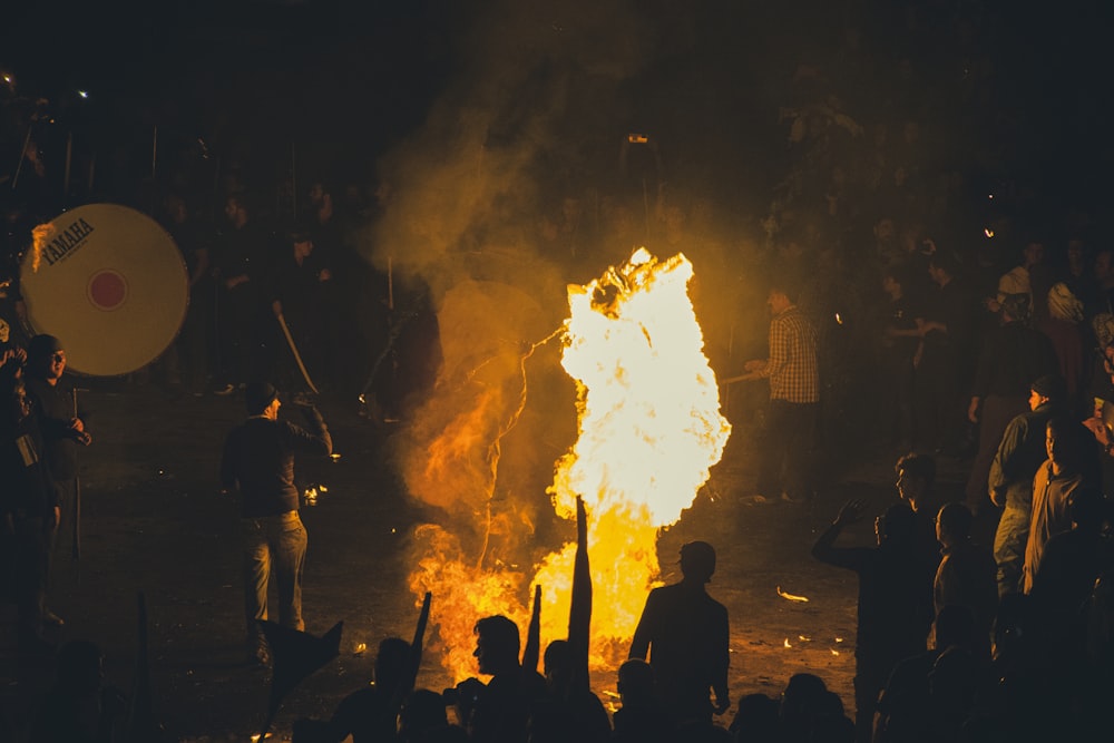 a group of people watching a bonfire