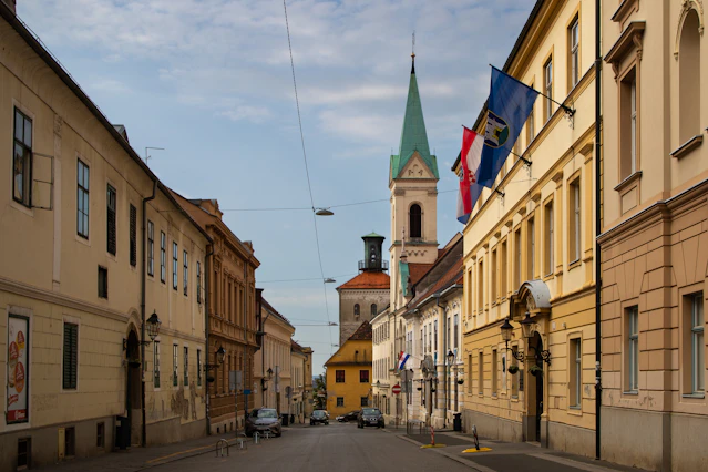 a street with buildings and flags on it