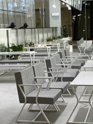 Sleek modern chair with metal legs in a bright franchise dining area.