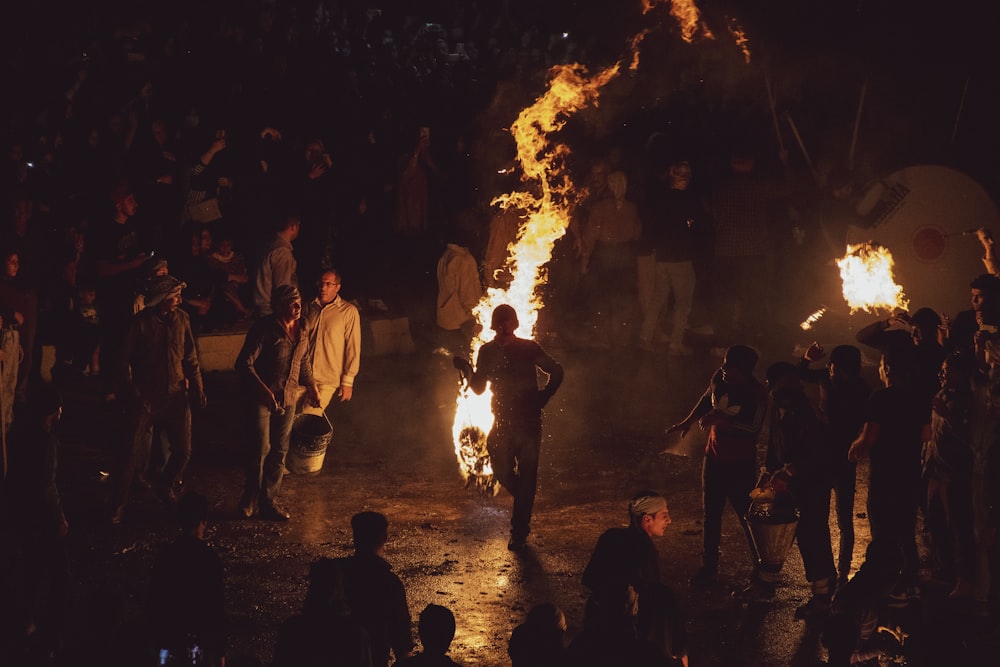 a group of people around a fire