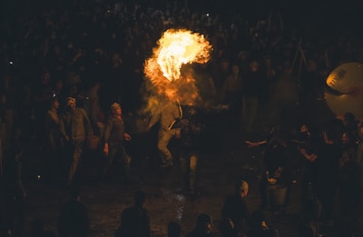 a group of people standing around a fire